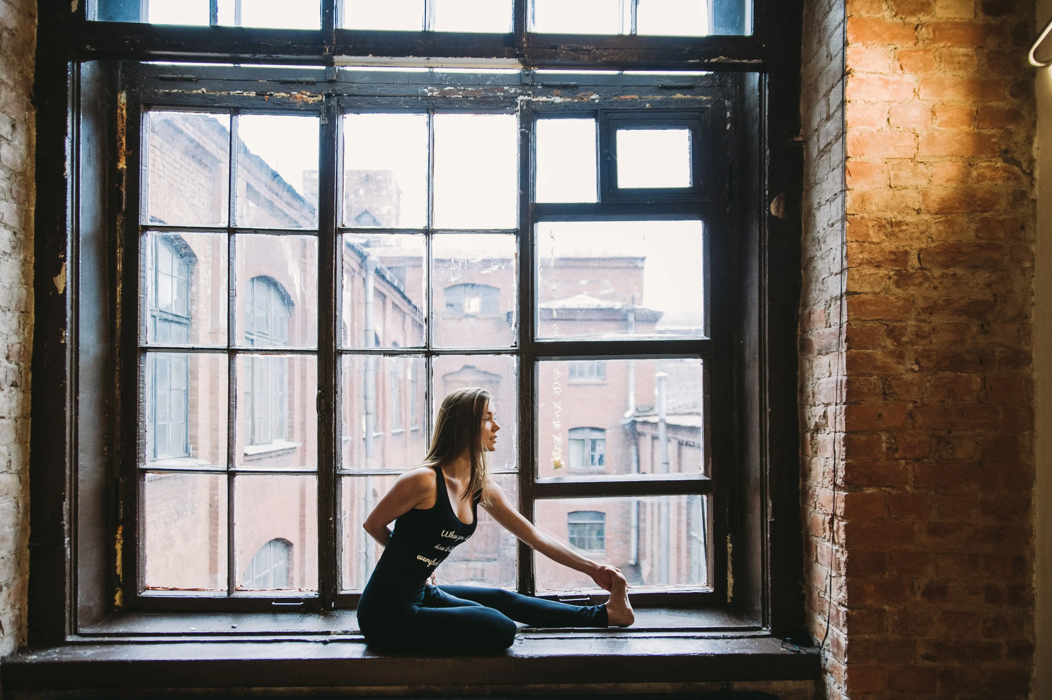 woman standing in front of huge window